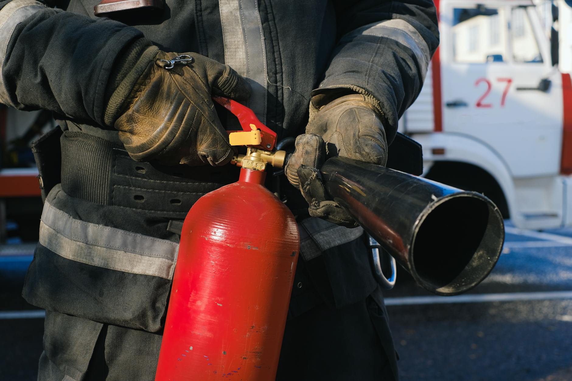 firefighter holding fire extinguisher